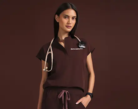 Video of a healthcare professional wearing FIGS Espresso scrubs, showcasing the limited-edition colorway and best-selling silhouette.