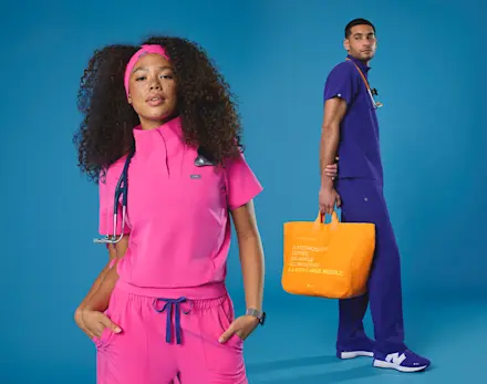 Video of healthcare professionals wearing FIGS Nurses Week scrubs in Rapid Response Pink, Deep Royal Blue, and Creamsicle against a bold blue backdrop, highlighting the limited-edition collection.