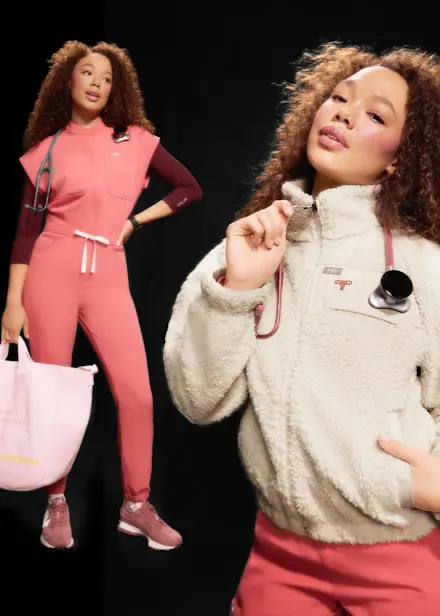Models wearing FIGS Pulmonary Pink scrubwear and accessories, with a cream fleece jacket layered over matching pink scrubs, introducing the limited-edition Valentine's Day color collection.