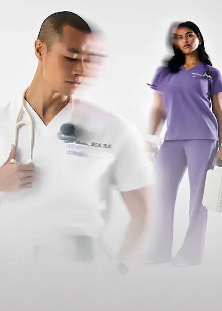 Healthcare professional in Optic White scrubs and healthcare professional in Amethyst purple scrubs standing against a white background.