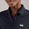 https://cdn.shopify.com/s/files/1/0139/8942/files/2025_Q2_05_NAVY_CHELSEAFORMXPOLOSCRUBTOP_AWA_1636.jpg?v=1747172352