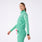 https://cdn.shopify.com/s/files/1/0139/8942/files/2025_Q2_05_SURGICAL-GREEN_LOMITA-FULL-ZIP_MADI_1324.jpg?v=1751324018