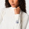 https://cdn.shopify.com/s/files/1/0139/8942/files/2026_Q1_01_OFF-WHITE_TEAM-USA-MOCK-NECK-LS-UNDERSCRUB_LAURYN_1758.jpg?v=1772135738