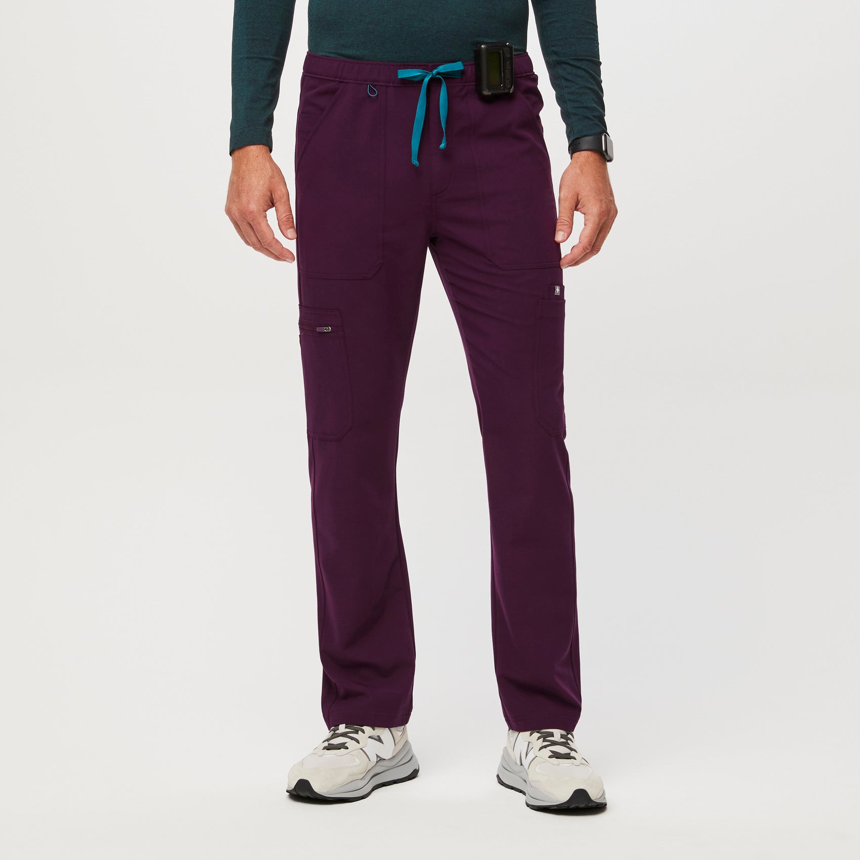 https://cdn.shopify.com/s/files/1/0139/8942/files/Q2_2023_06_DEEP-PURPLE_CAIRO-CARGO-SCRUB-PANTS_M_COREY_34620.jpg?v=1690922764