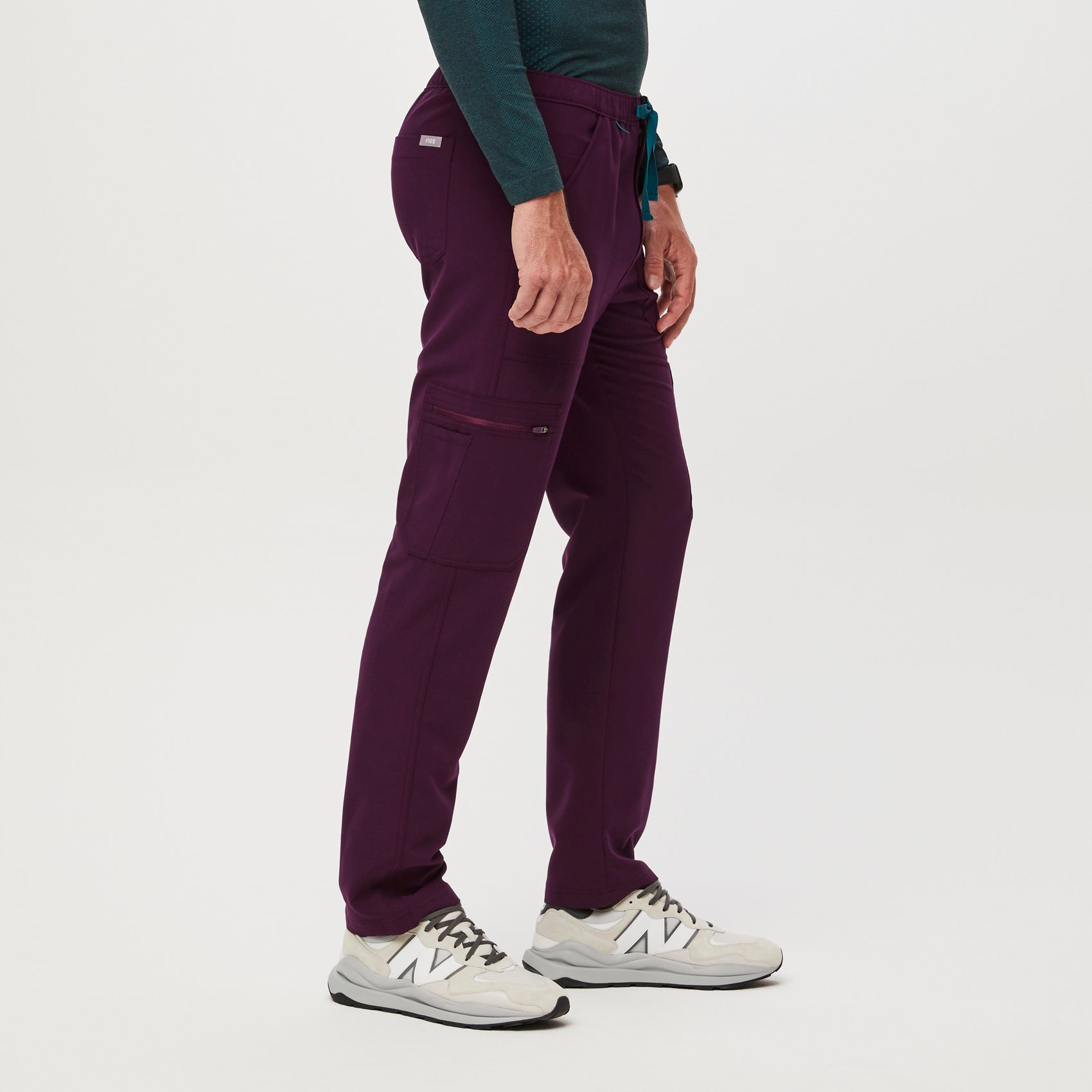 https://cdn.shopify.com/s/files/1/0139/8942/files/Q2_2023_06_DEEP-PURPLE_CAIRO-CARGO-SCRUB-PANTS_M_COREY_34638.jpg?v=1690222200