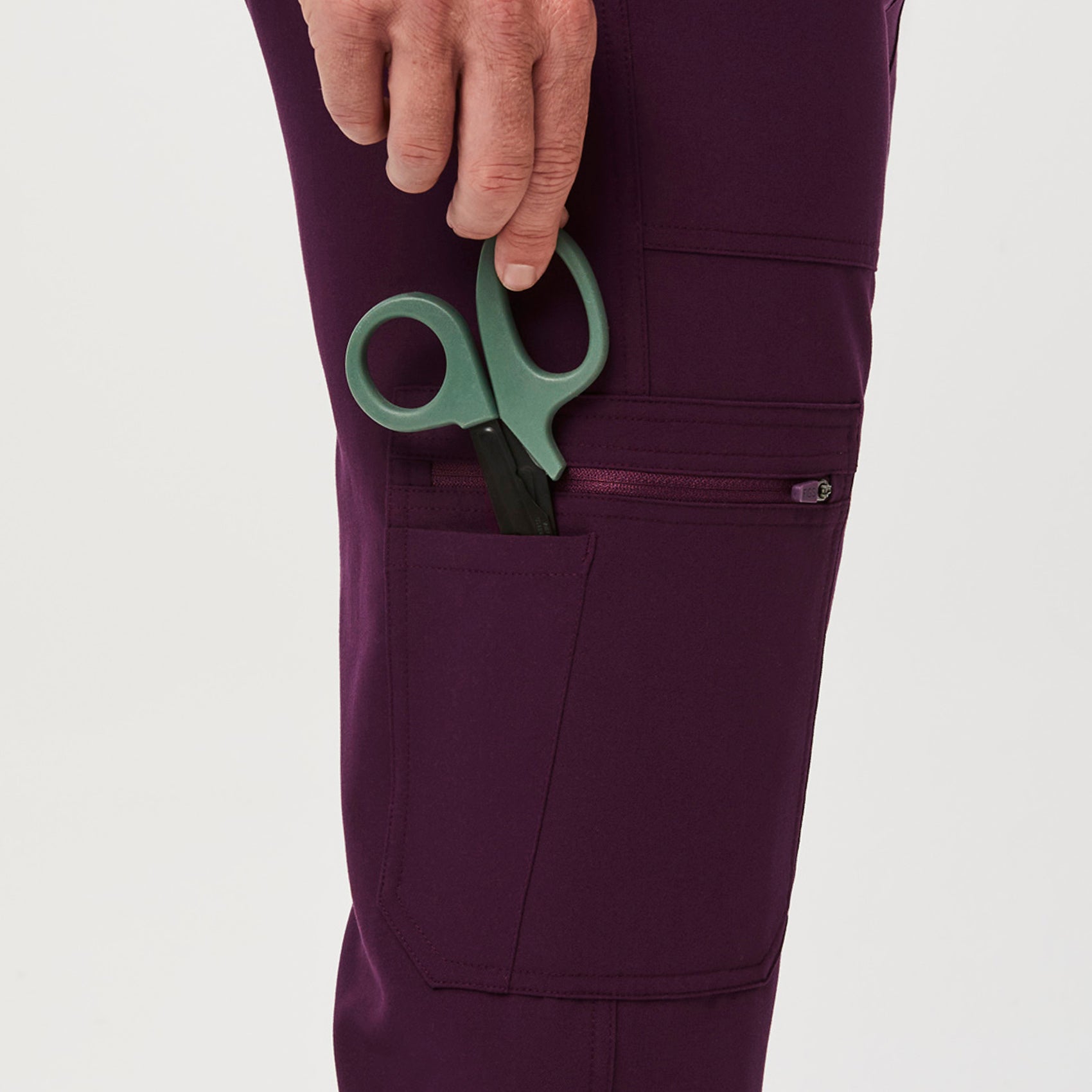 https://cdn.shopify.com/s/files/1/0139/8942/files/Q2_2023_06_DEEP-PURPLE_CAIRO-CARGO-SCRUB-PANTS_M_COREY_34650.jpg?v=1690222196