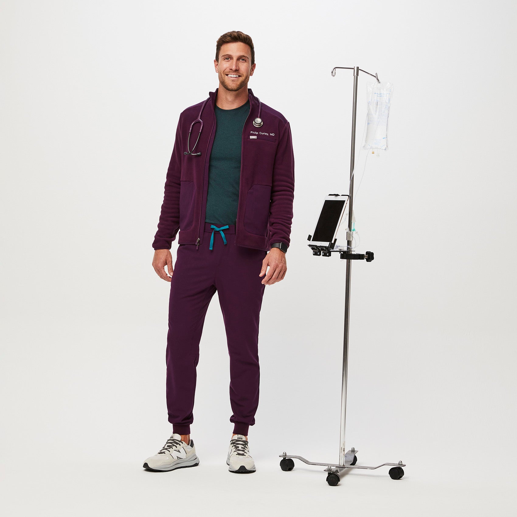 https://cdn.shopify.com/s/files/1/0139/8942/files/Q2_2023_06_DEEP-PURPLE_TANSEN-SLIM-JOGGER-SCRUB-PANTS_M_COREY_34513.jpg?v=1690220862