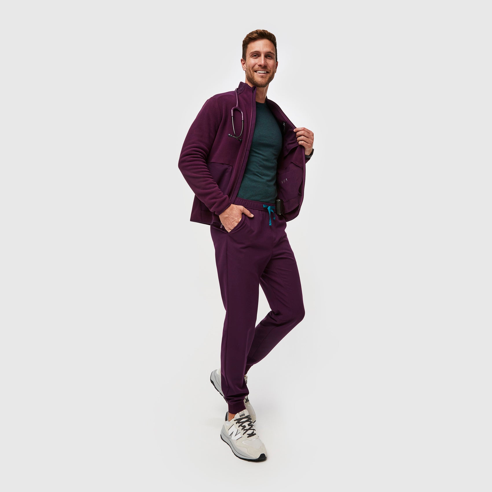https://cdn.shopify.com/s/files/1/0139/8942/files/Q2_2023_06_DEEP-PURPLE_TANSEN-SLIM-JOGGER-SCRUB-PANTS_M_COREY_34545.jpg?v=1690220862