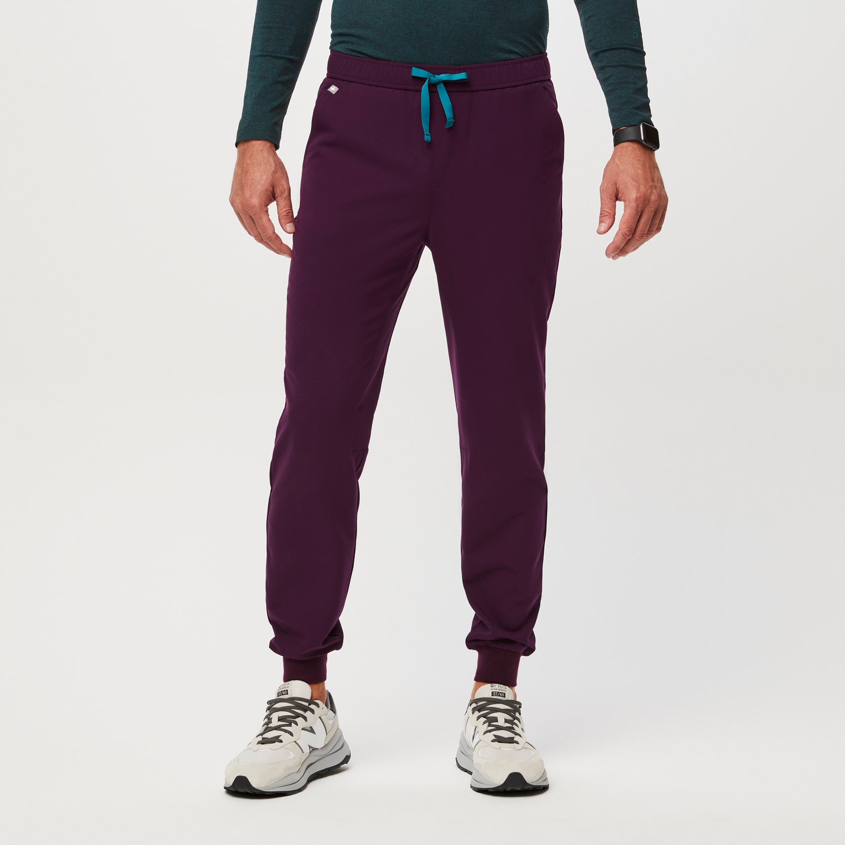 https://cdn.shopify.com/s/files/1/0139/8942/files/Q2_2023_06_DEEP-PURPLE_TANSEN-SLIM-JOGGER-SCRUB-PANTS_M_COREY_34567.jpg?v=1690220862