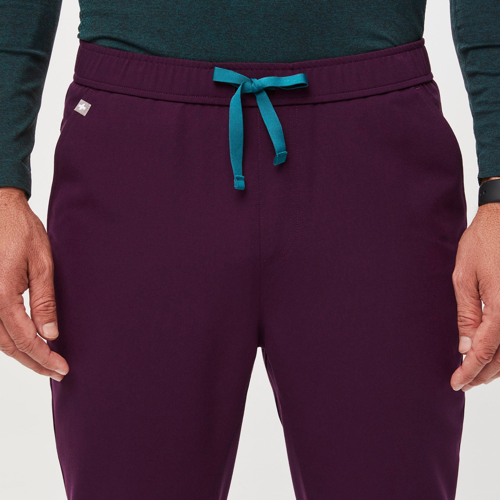 https://cdn.shopify.com/s/files/1/0139/8942/files/Q2_2023_06_DEEP-PURPLE_TANSEN-SLIM-JOGGER-SCRUB-PANTS_M_COREY_34573.jpg?v=1690220875