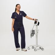 https://cdn.shopify.com/s/files/1/0139/8942/files/Q2_2023_06_NAVY_CATARINA-SCRUB-JUMPSUIT_W_SALOME_28443.jpg?v=1689701275