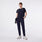 https://cdn.shopify.com/s/files/1/0139/8942/files/Q2_2024_4_NAVY_LILLIEHIGHWAISTEDSLIMTAPEREDSCRUBPANT_MELANIE1658_9862dc8b-7de1-43b8-8591-2ba7a79cda70.jpg?v=1714153572