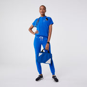 https://cdn.shopify.com/s/files/1/0139/8942/files/Q2_2024_6_ROYALBLUE_MONTEXSCRUBTOP_DEJA_773.jpg?v=1719357810
