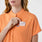 https://cdn.shopify.com/s/files/1/0139/8942/files/Q3_2024_7_SHAKAORANGE_MONTEXSCRUBTOP_CLARA_175.jpg?v=1723238186