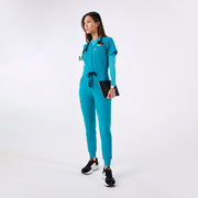 https://cdn.shopify.com/s/files/1/0139/8942/files/Q4_2024_12_TEAL_CATARINAV-NECKJUMPSUIT_CHARO_1413.jpg?v=1736357329