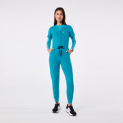 https://cdn.shopify.com/s/files/1/0139/8942/files/Q4_2024_12_TEAL_CATARINAV-NECKJUMPSUIT_CHARO_1435.jpg?v=1736841746