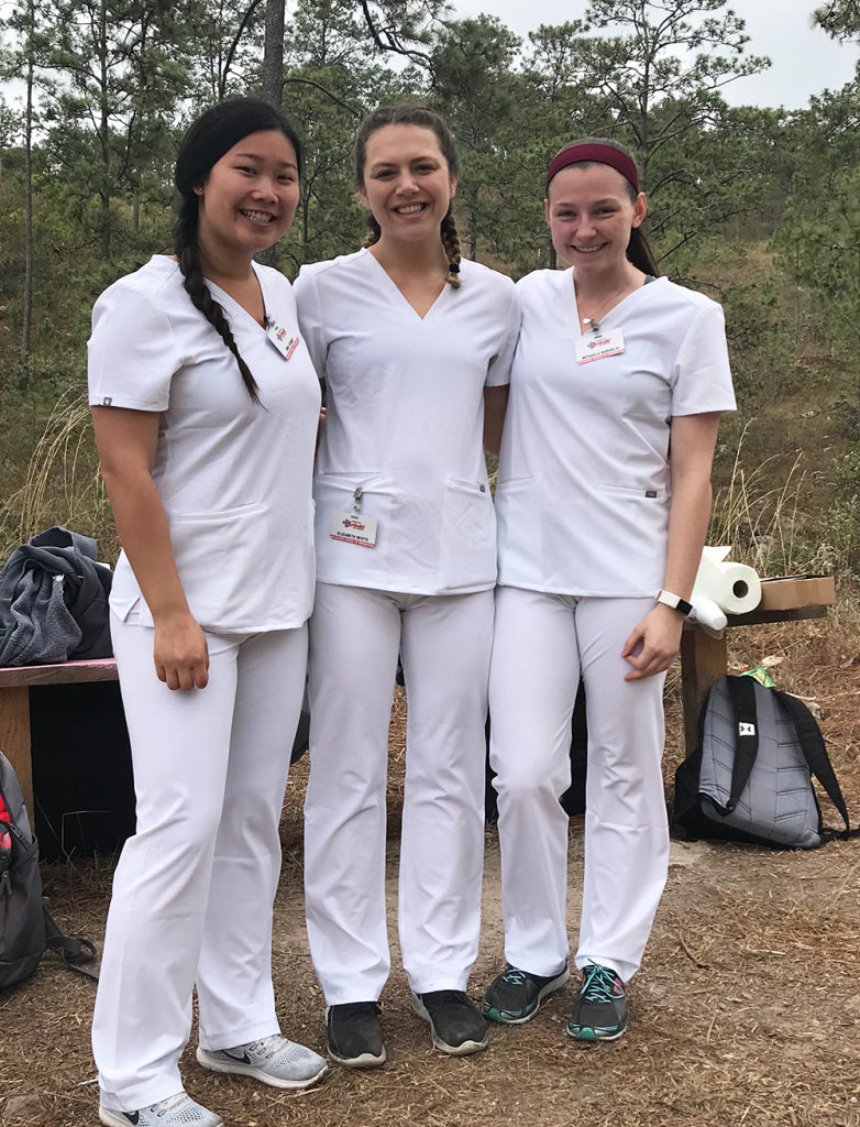 Three nurses in white scrubs