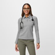 https://cdn.shopify.com/s/files/1/0139/8942/products/Q1_2023_02_HEATHER-GREY_SLIM-TECHNICAL-LS-POLO_W_NATALIE_32187.jpg?v=1680543047